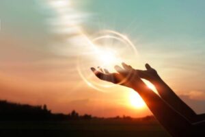 Hands reach out to the sun to represent faith-based counseling