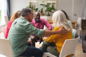 People sit in circle and bond while in mental health disorder treatment